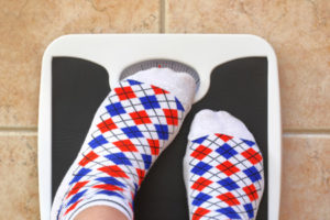 37490636 - woman's feet on bathroom scale. diet concept